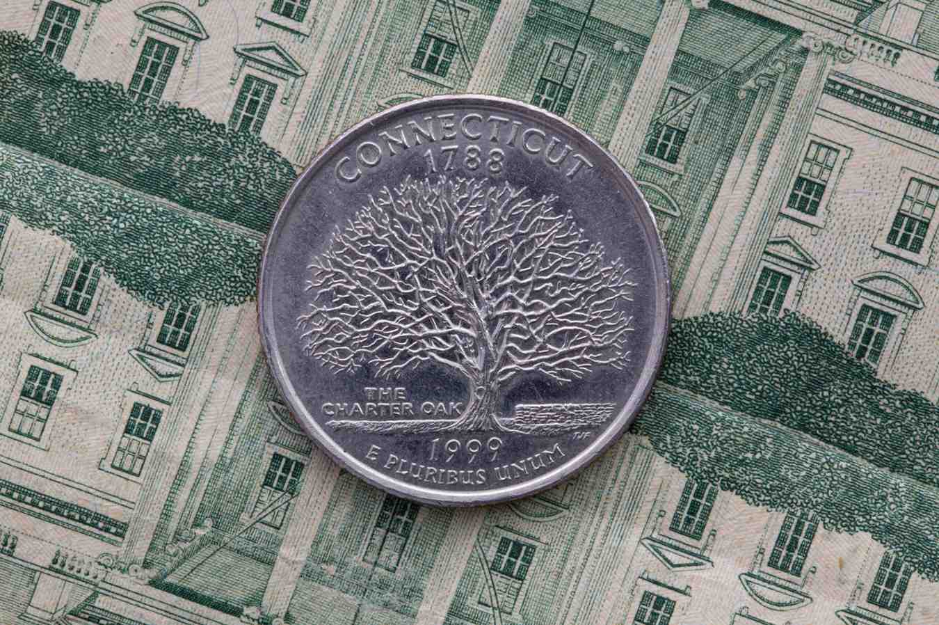 A quarter of Connecticut on US dollar bills. Symmetric composition of US dollar bills and a quarter of Connecticut.